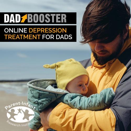 Dad holding baby at a windy beach