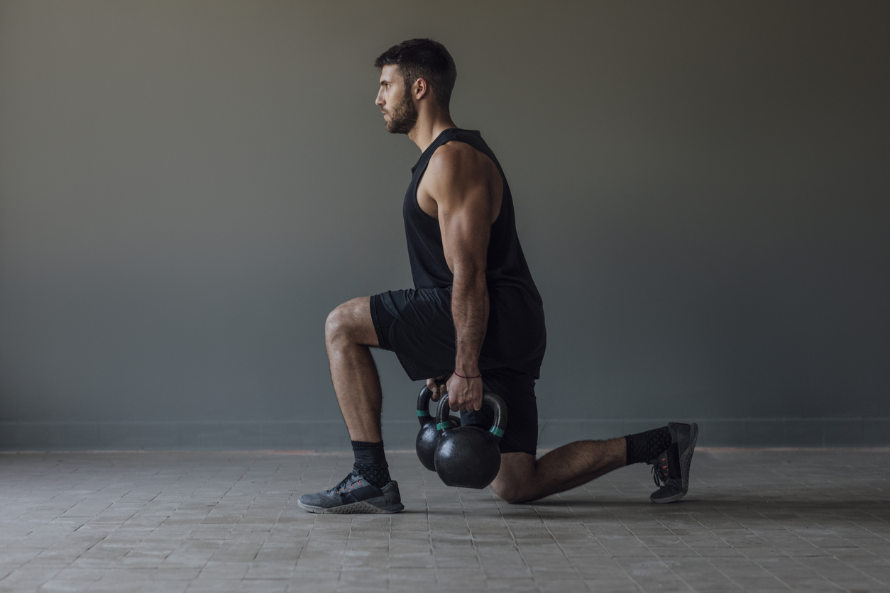 a man doing a kettlebell lunge