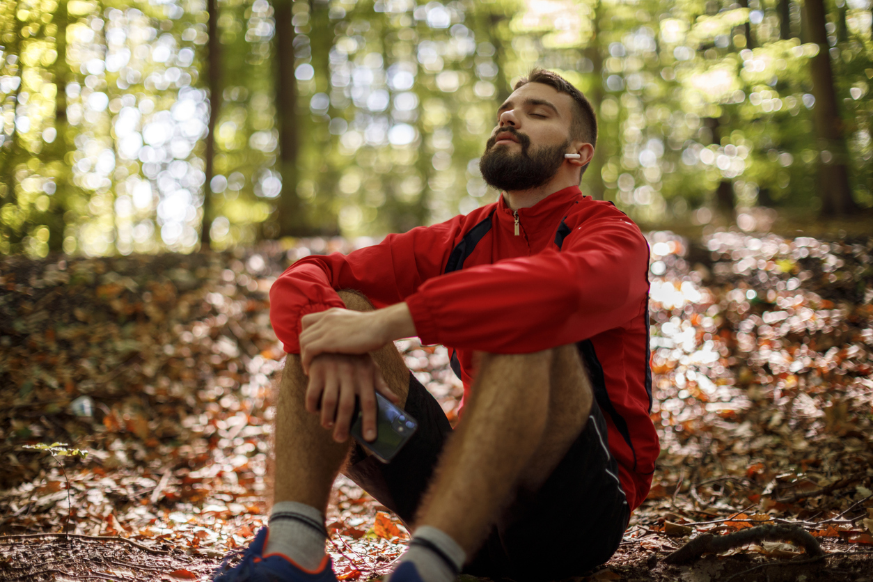 man sitting outside with his eyes closed