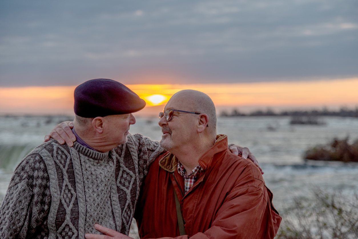 gay couple hugging outdoors