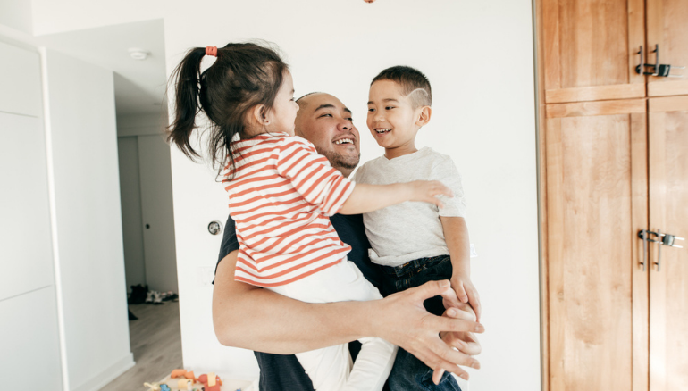 dad holding kids