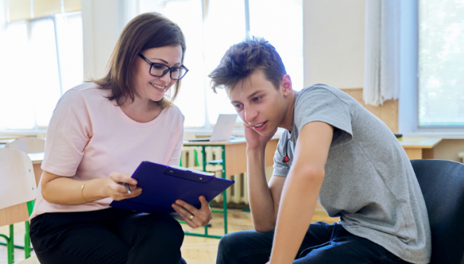 teenage boy talking to doctor screening