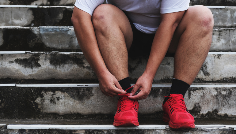 man tying up shoelaces