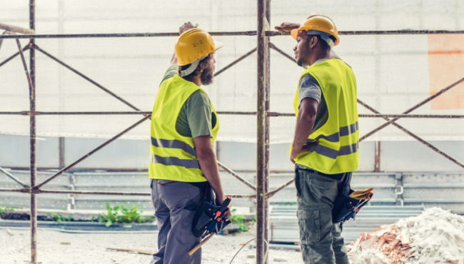 two men talking at construction site