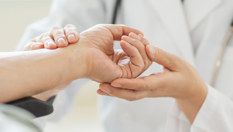 Doctor drawing blood from man's arm