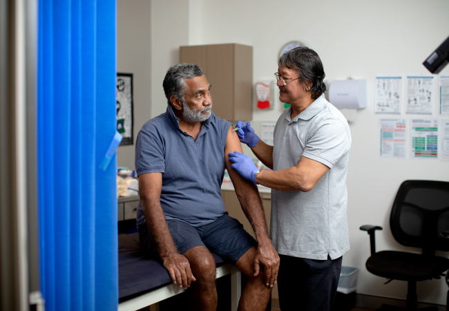 Aboriginal man having immunisation