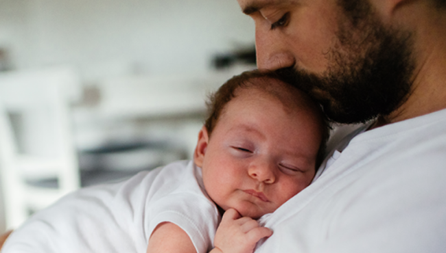 Man with baby laying on his chest