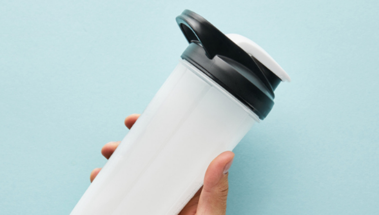 man holding protein shake