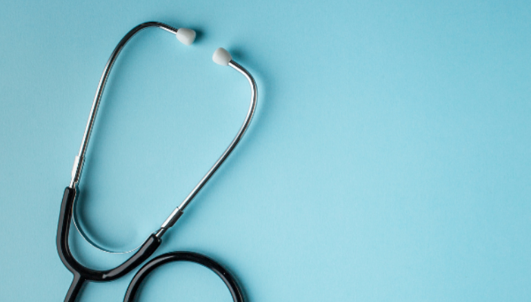 Silver stethoscope on blue background