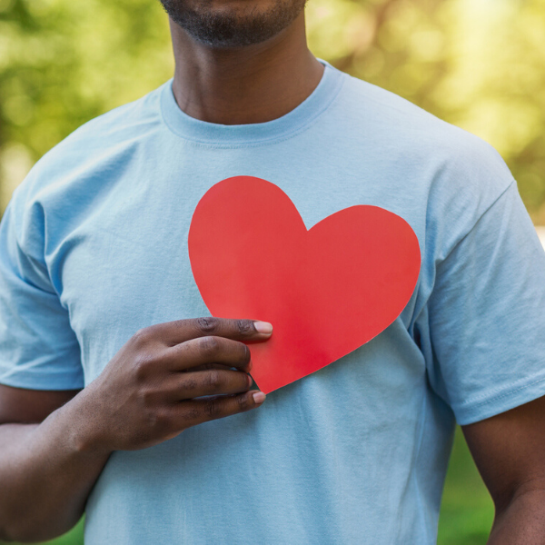 man-holding-heart-shape-to-chest 